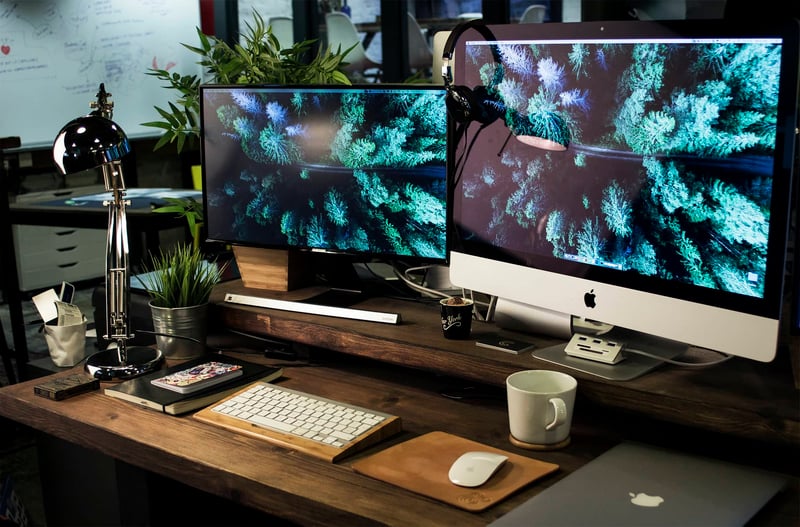 Two computer monitors on desk