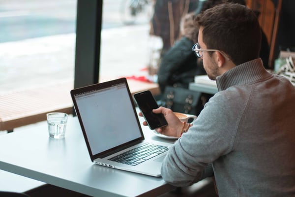 man on laptop in a cafe