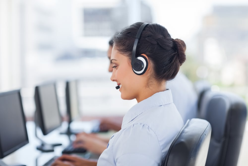 Attractive brunette working in a call centre with her headset