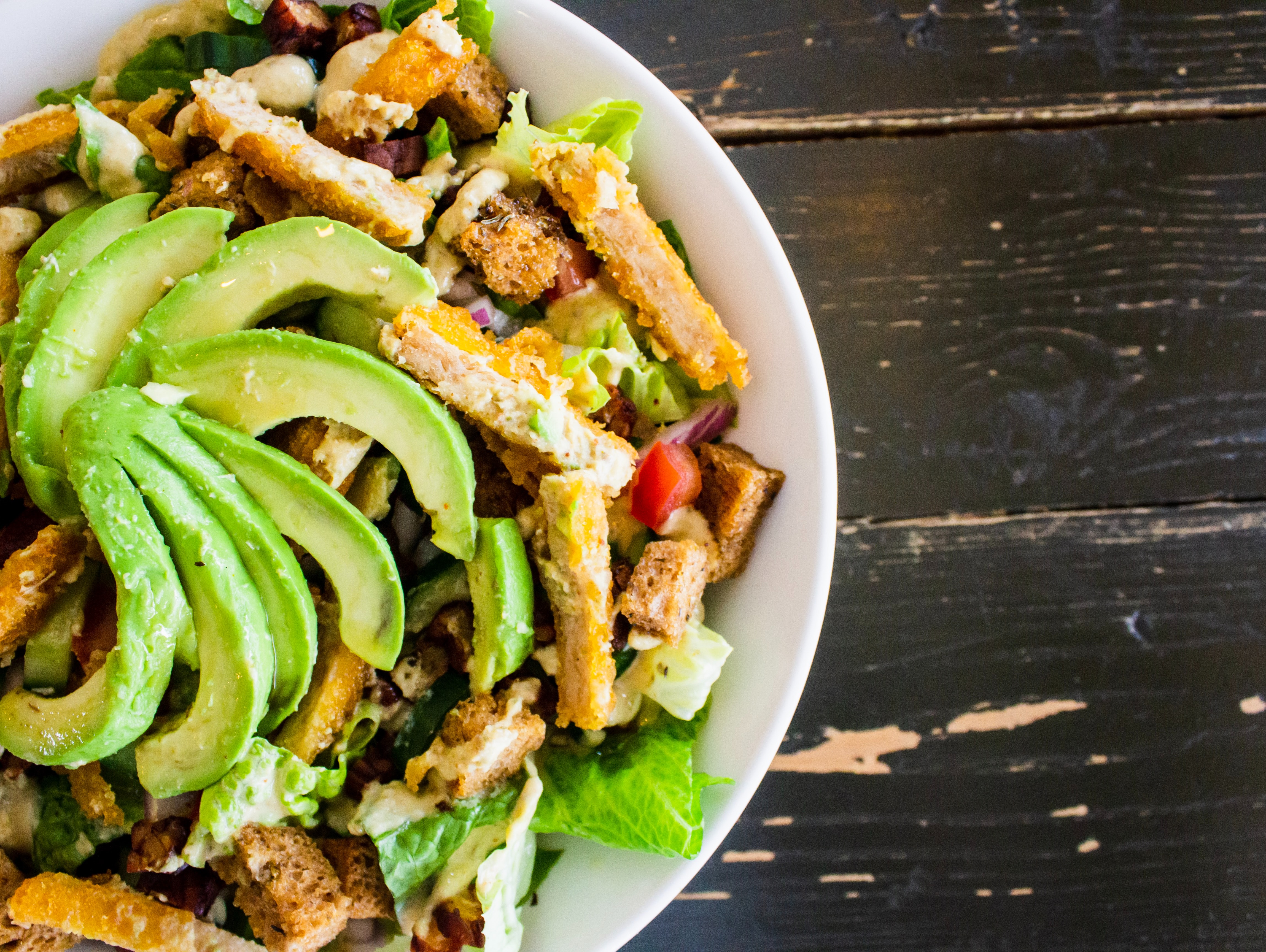 Salad bowl with lettuce, avocado, and chicken