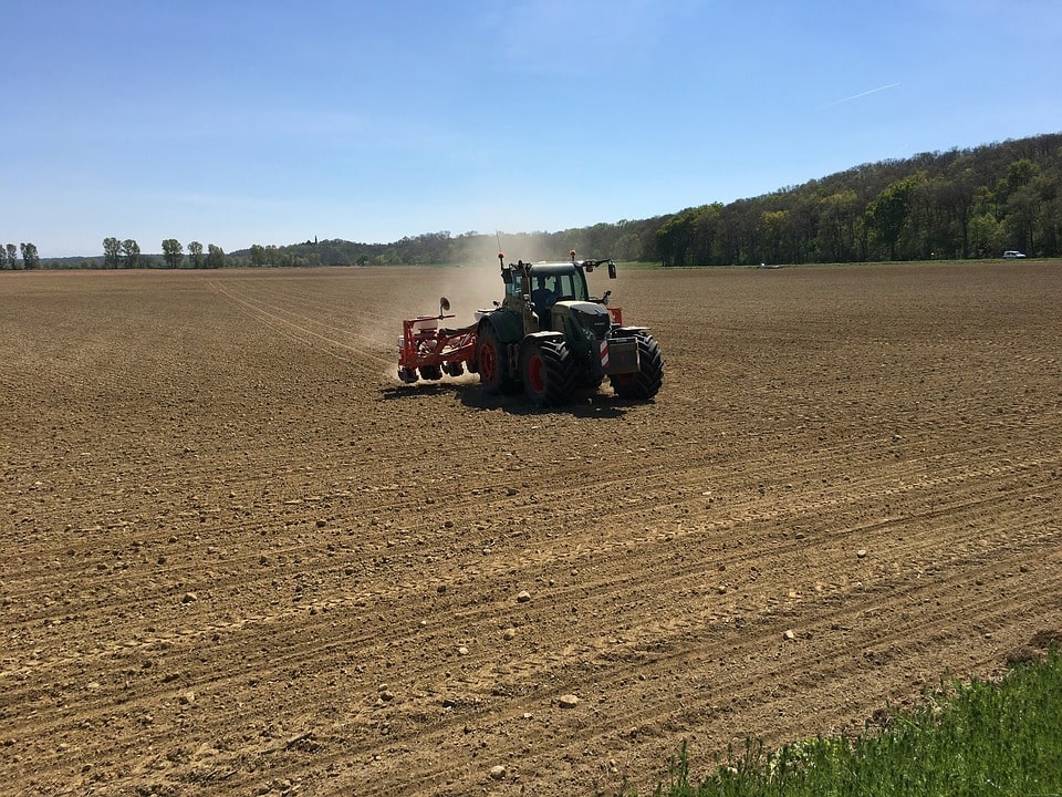 Tractor working the earth in a field