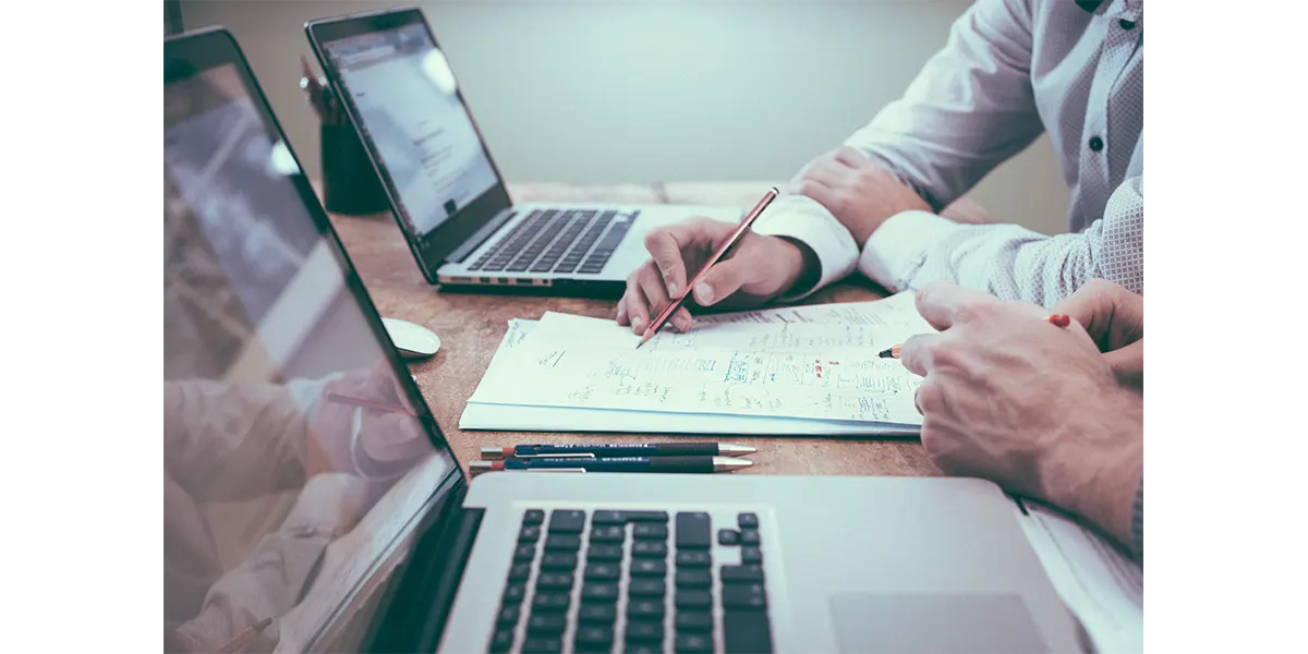 two laptops and a notebook