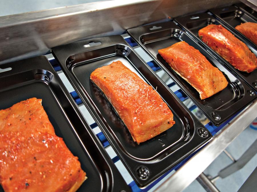 Salmon fillets on a SEALPAC line
