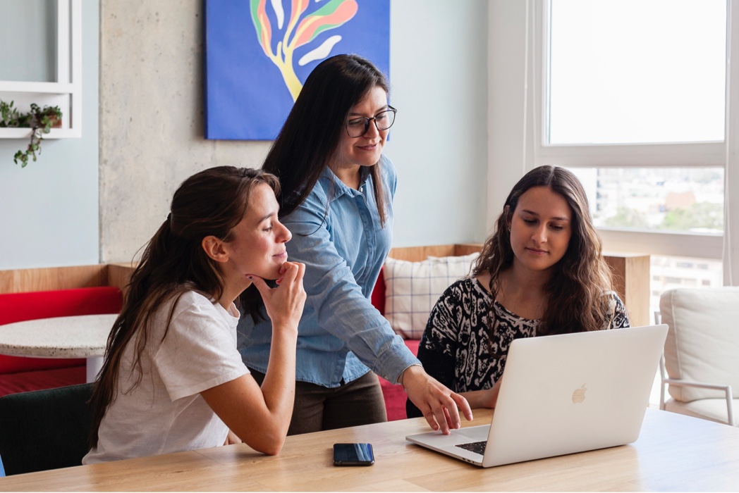 three women looking at laptop