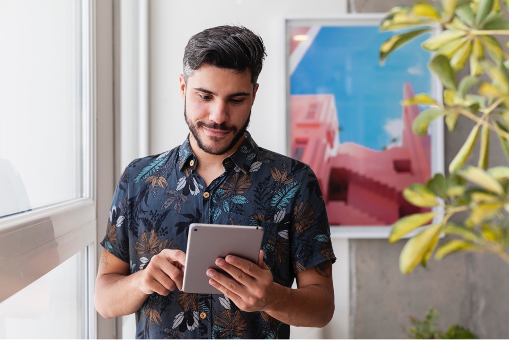 man looking at ipad tablet