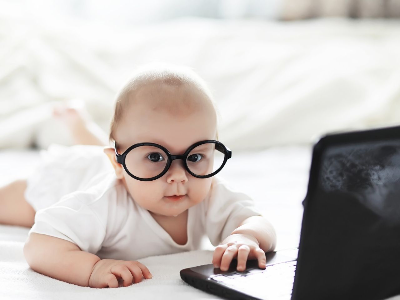 Baby wearing black framed glasses