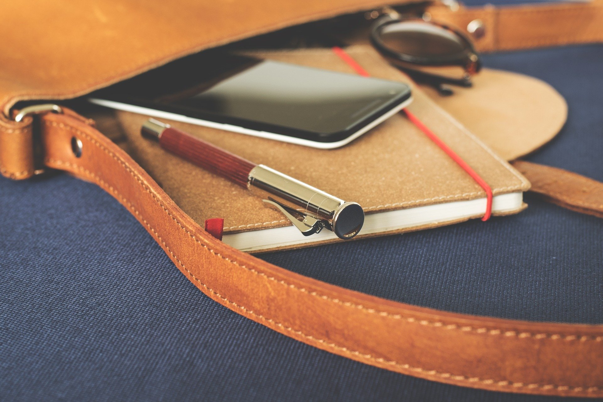 Bag with notebook, pen and smartphone
