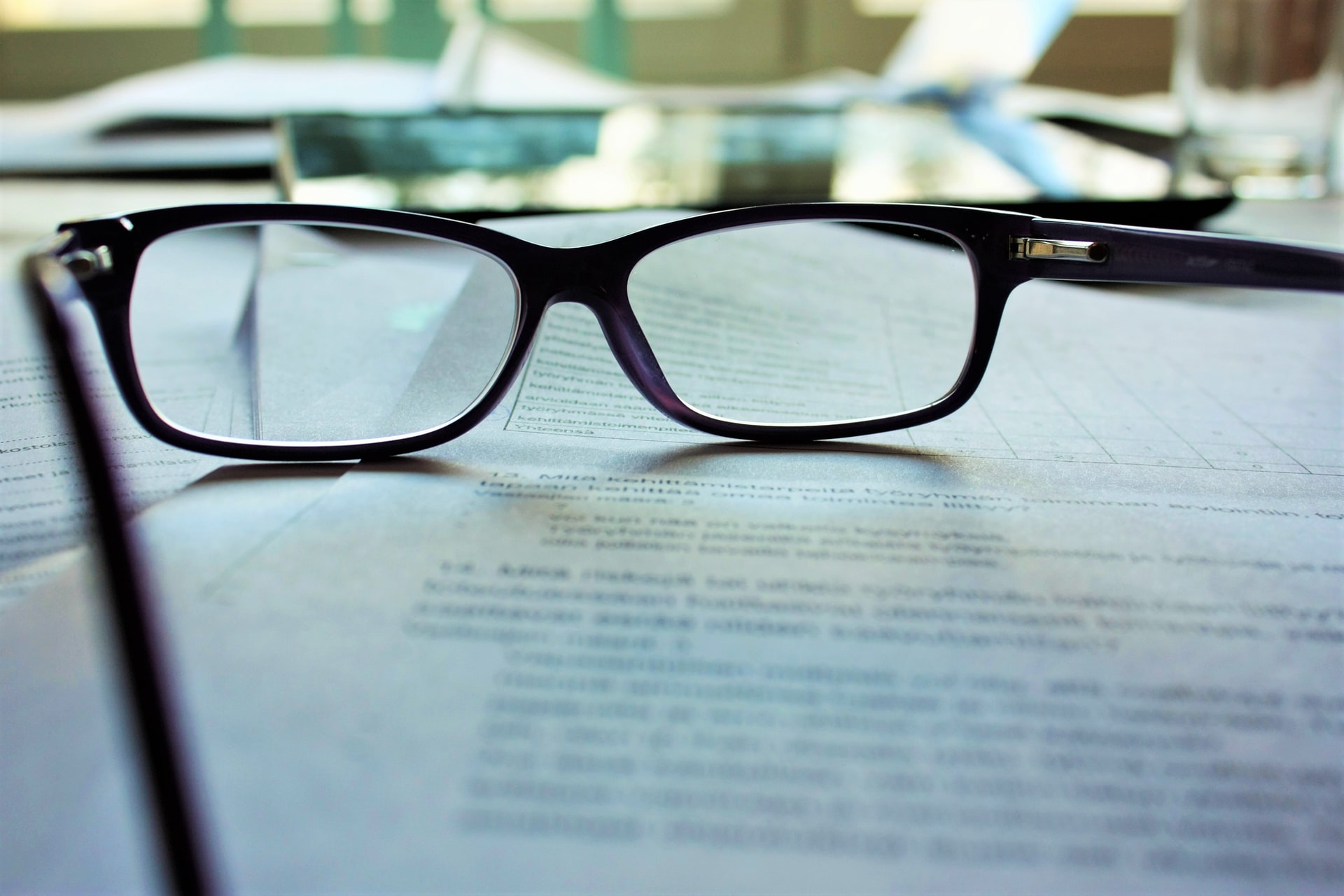 Black framed glasses on white paper