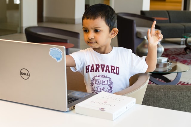 Boy wearing white Harvard tshirt