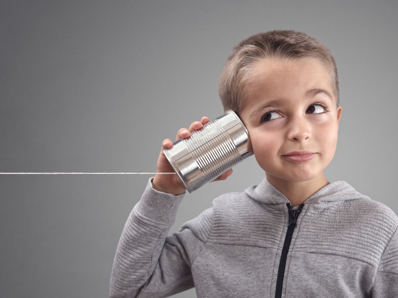 Child listening to a can