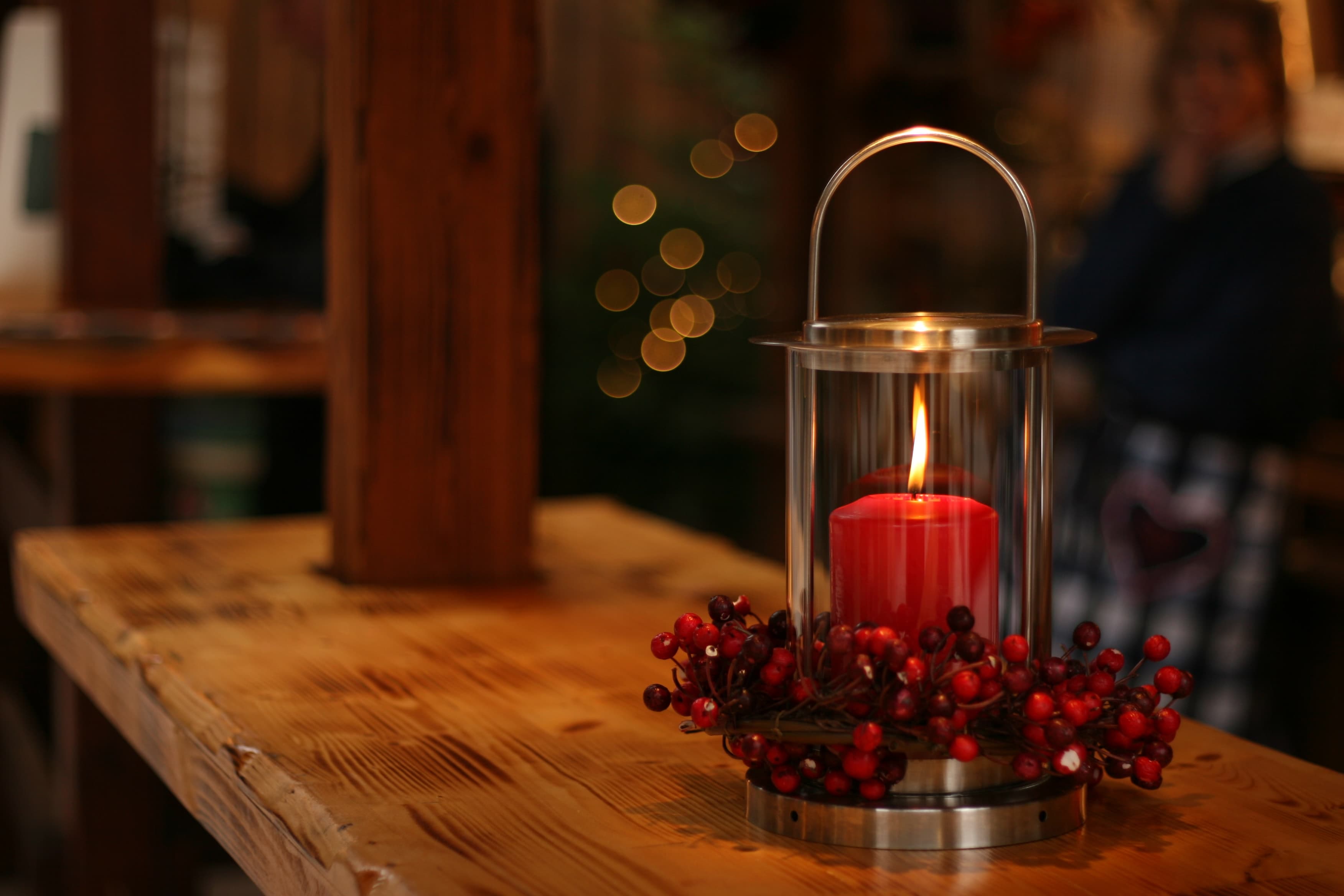 Christmas candle among rich wooden background