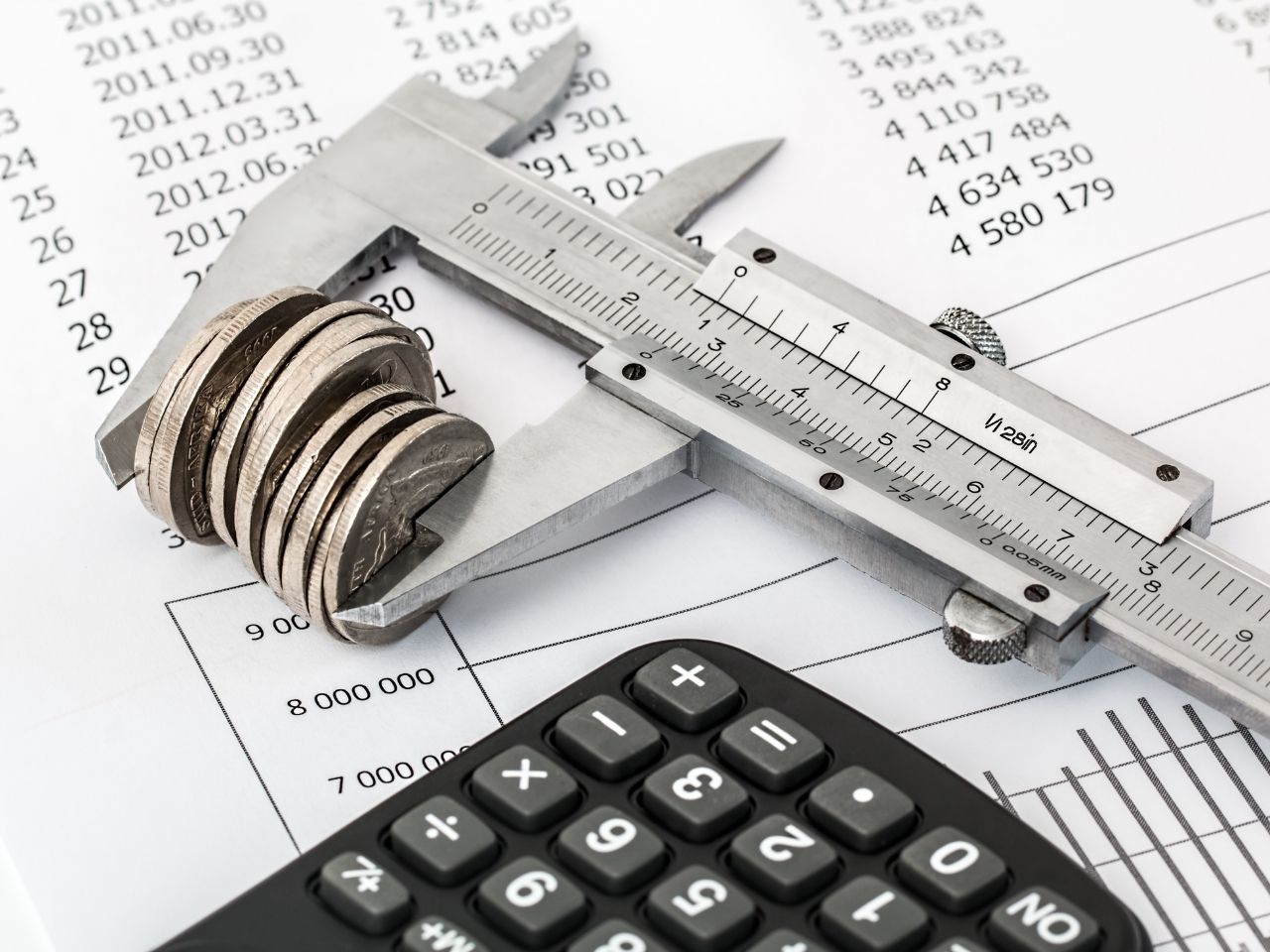 Coins near a black calculator