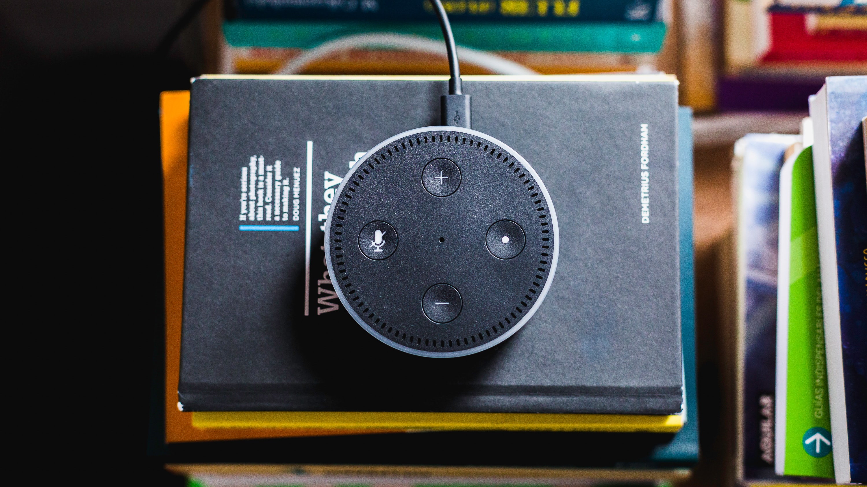 Echo Dot on top of stack of books