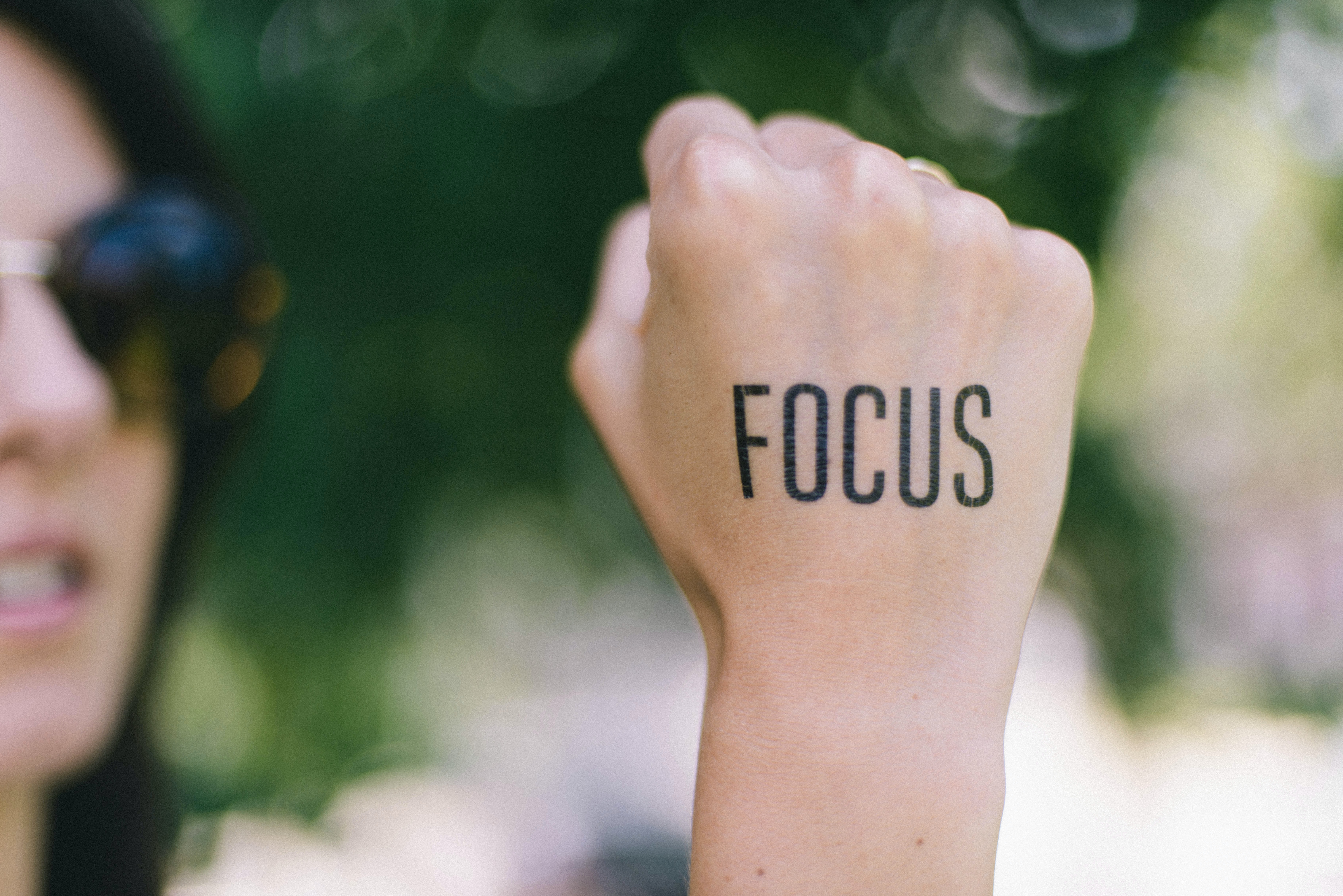 Focus written on persons hand