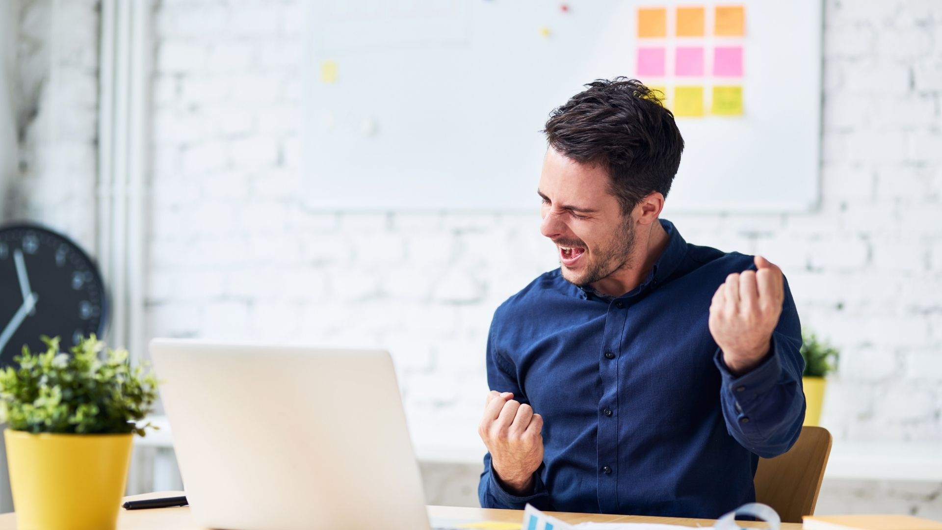 Happy man in front of a laptop