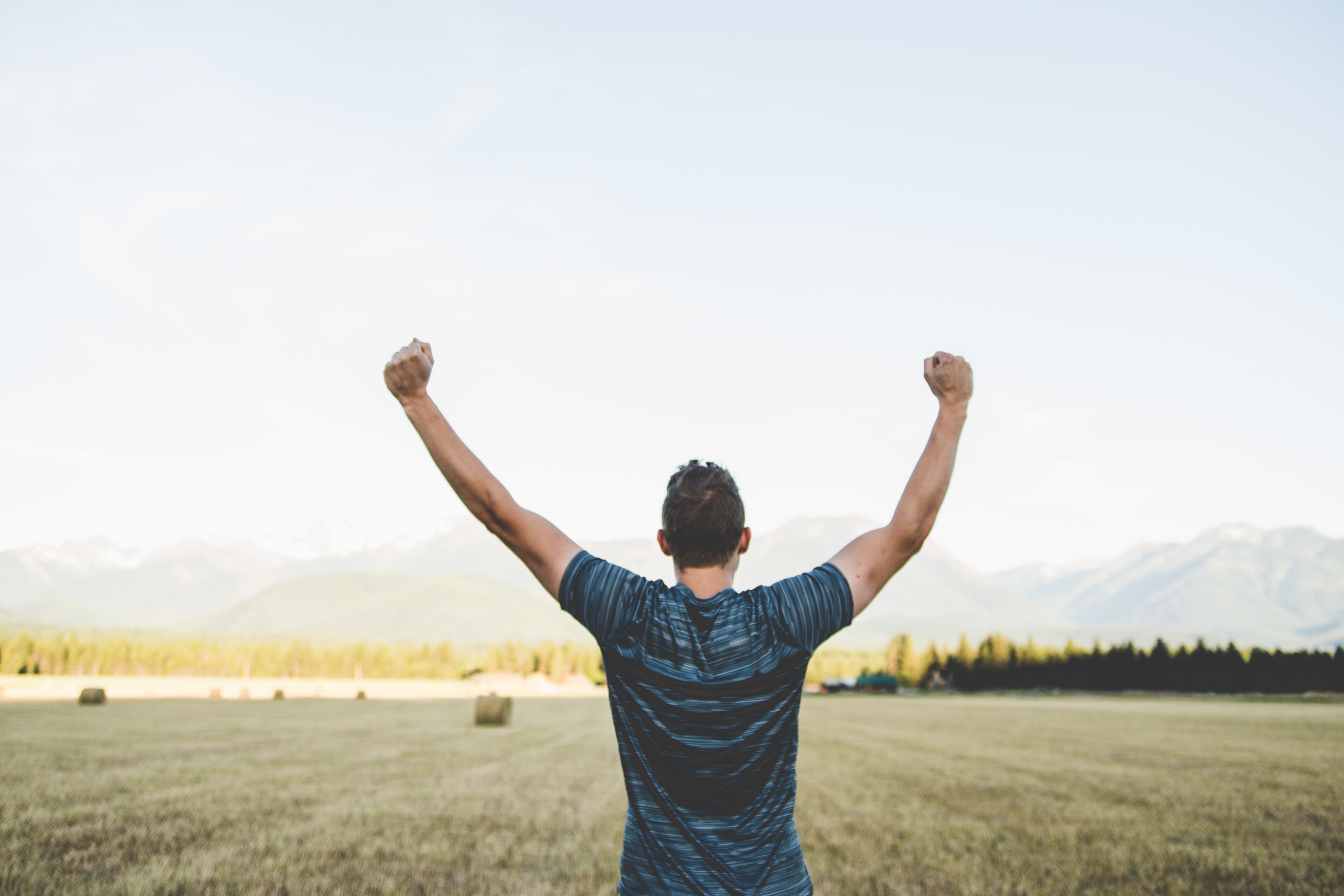 Happy person raising their arms in air