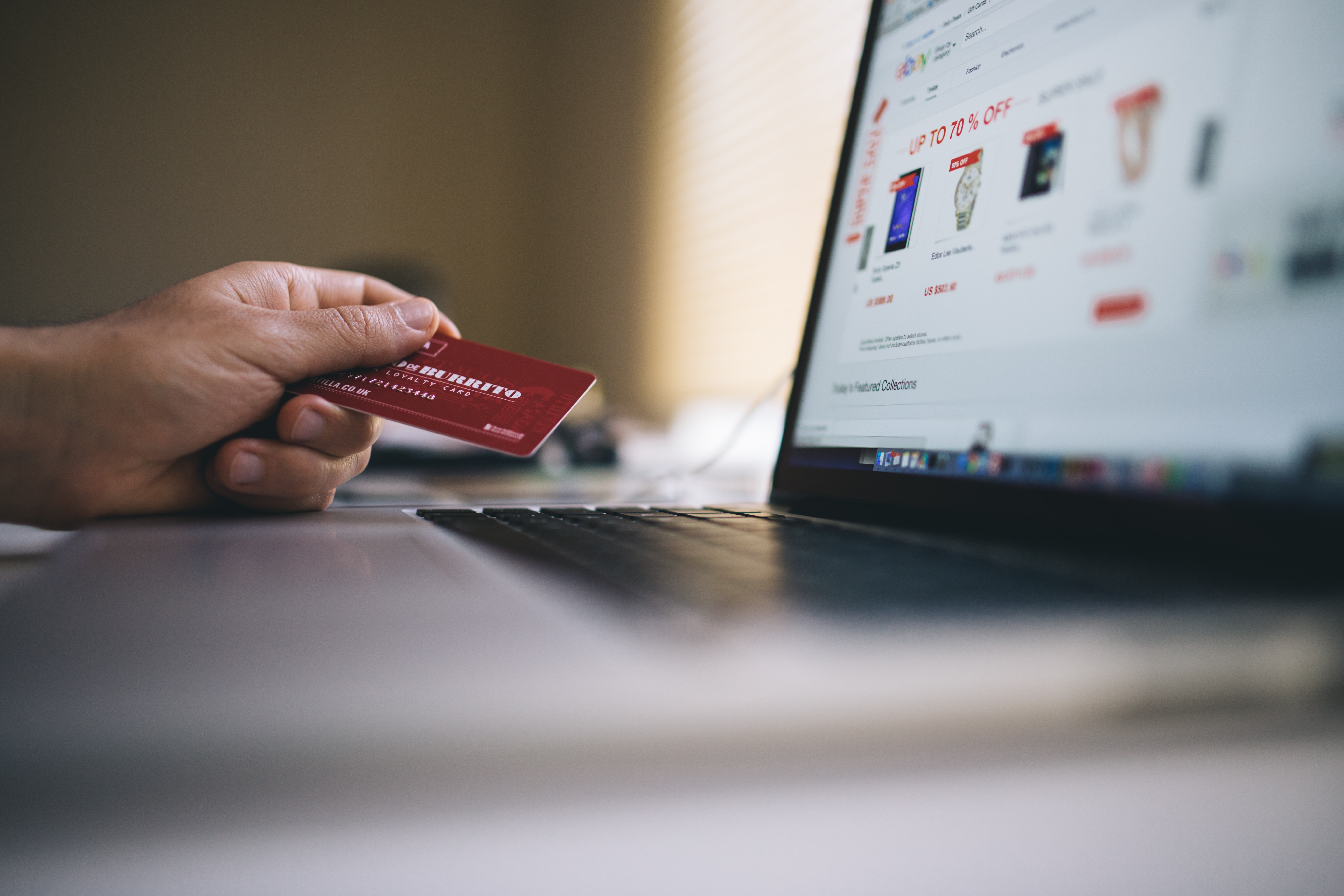 Man holding red credit card