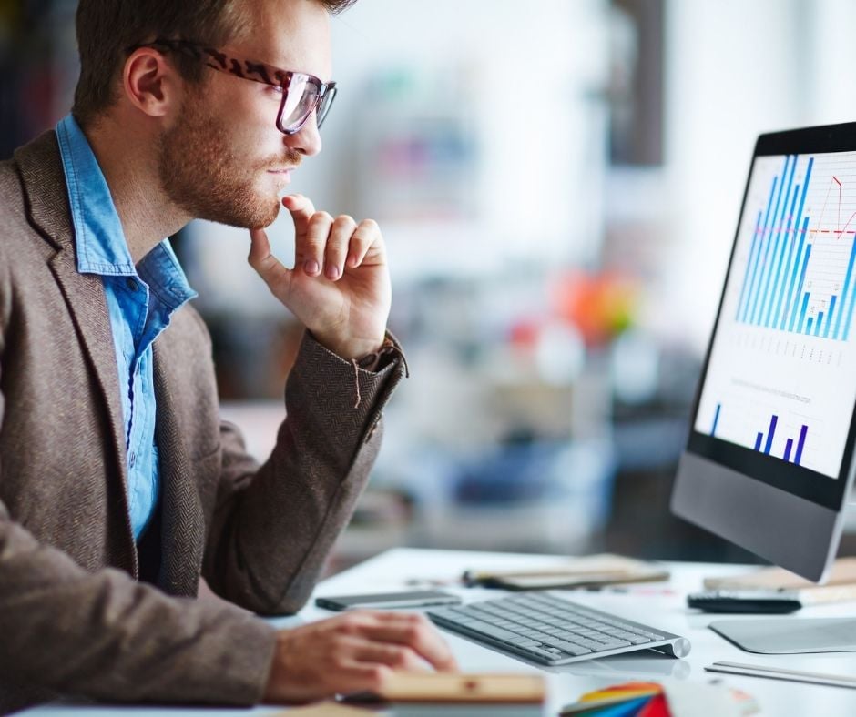 Man looking at an analytic monitor