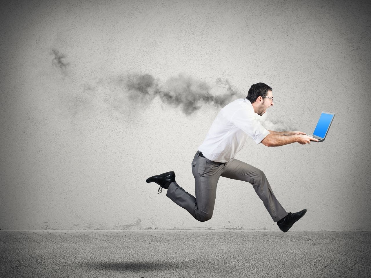 Man running with a smoking laptop