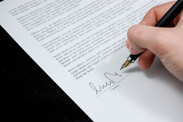 Man signing white paper