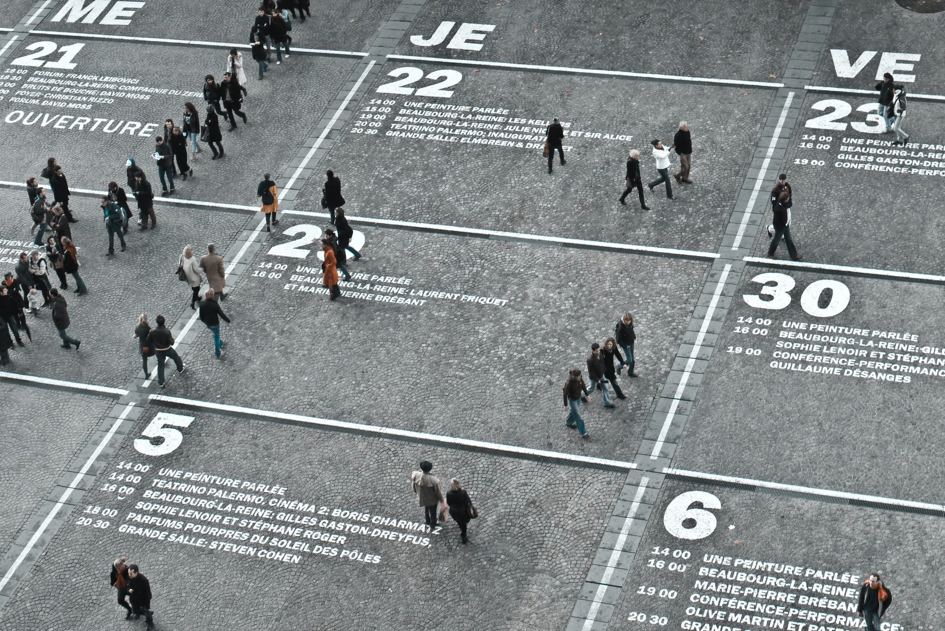 People walking a street with numbers