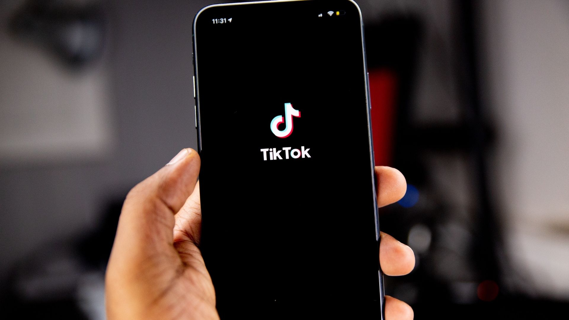 Person holding a phone with TikTok