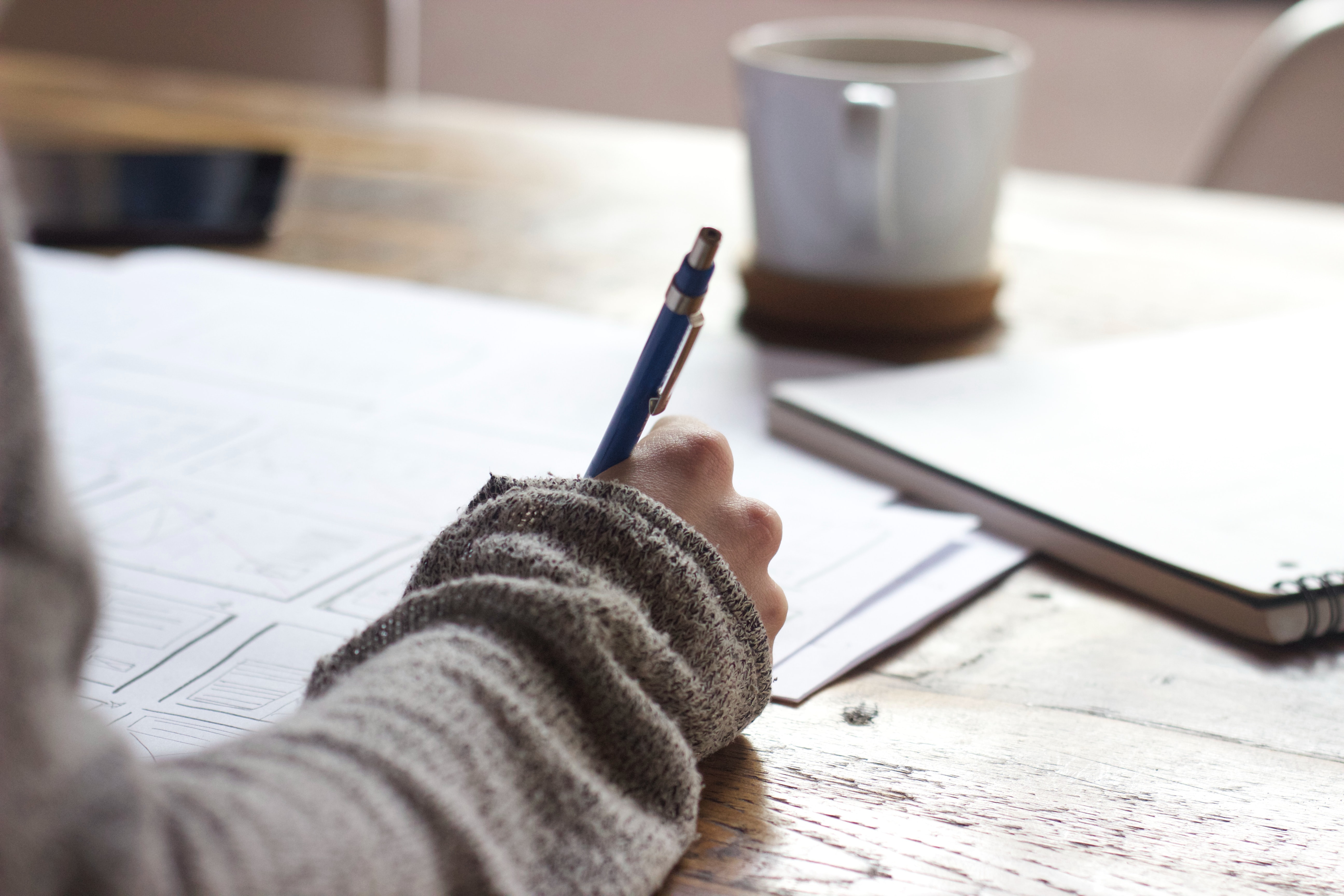 Person writing in notebook