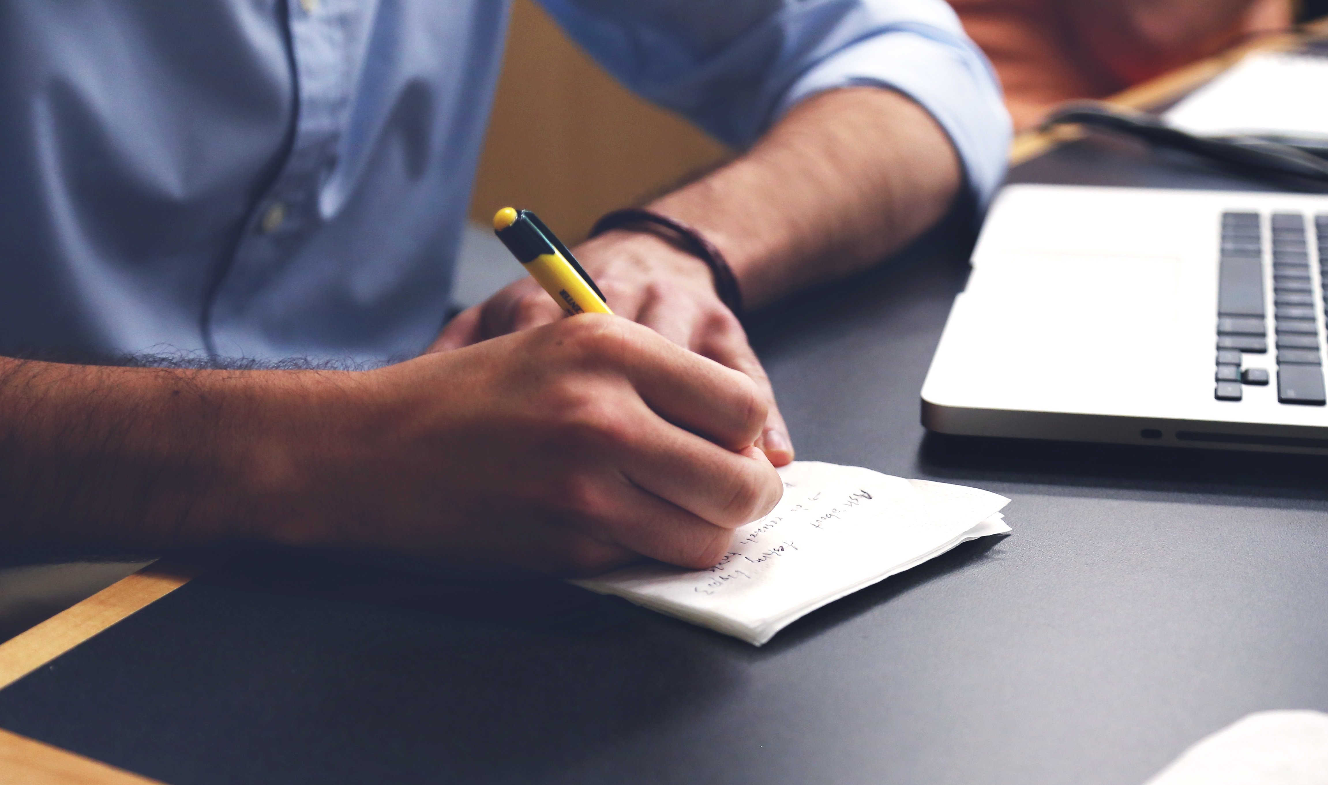 Person writing plan on paper