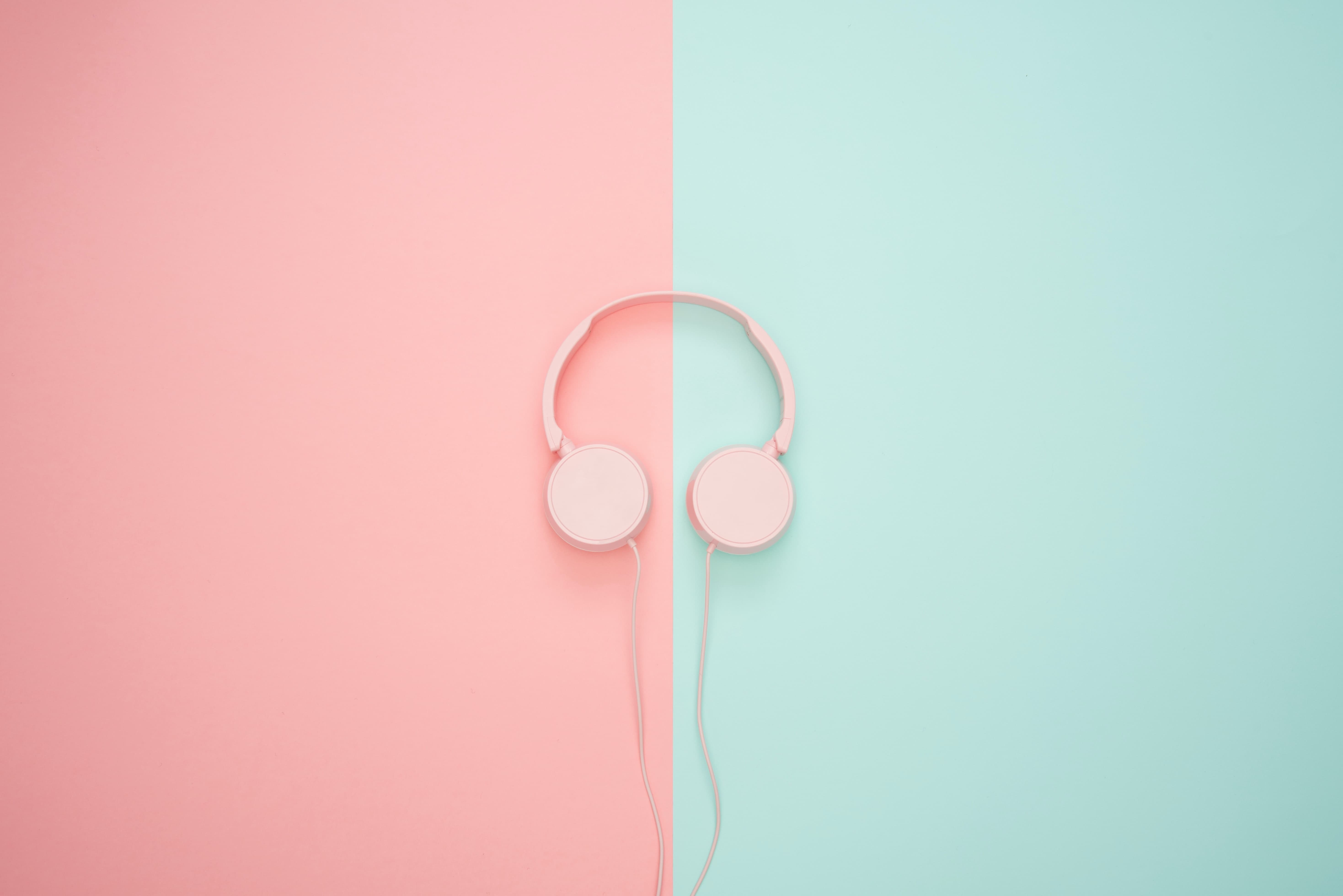 Pink headphones on pink and blue background