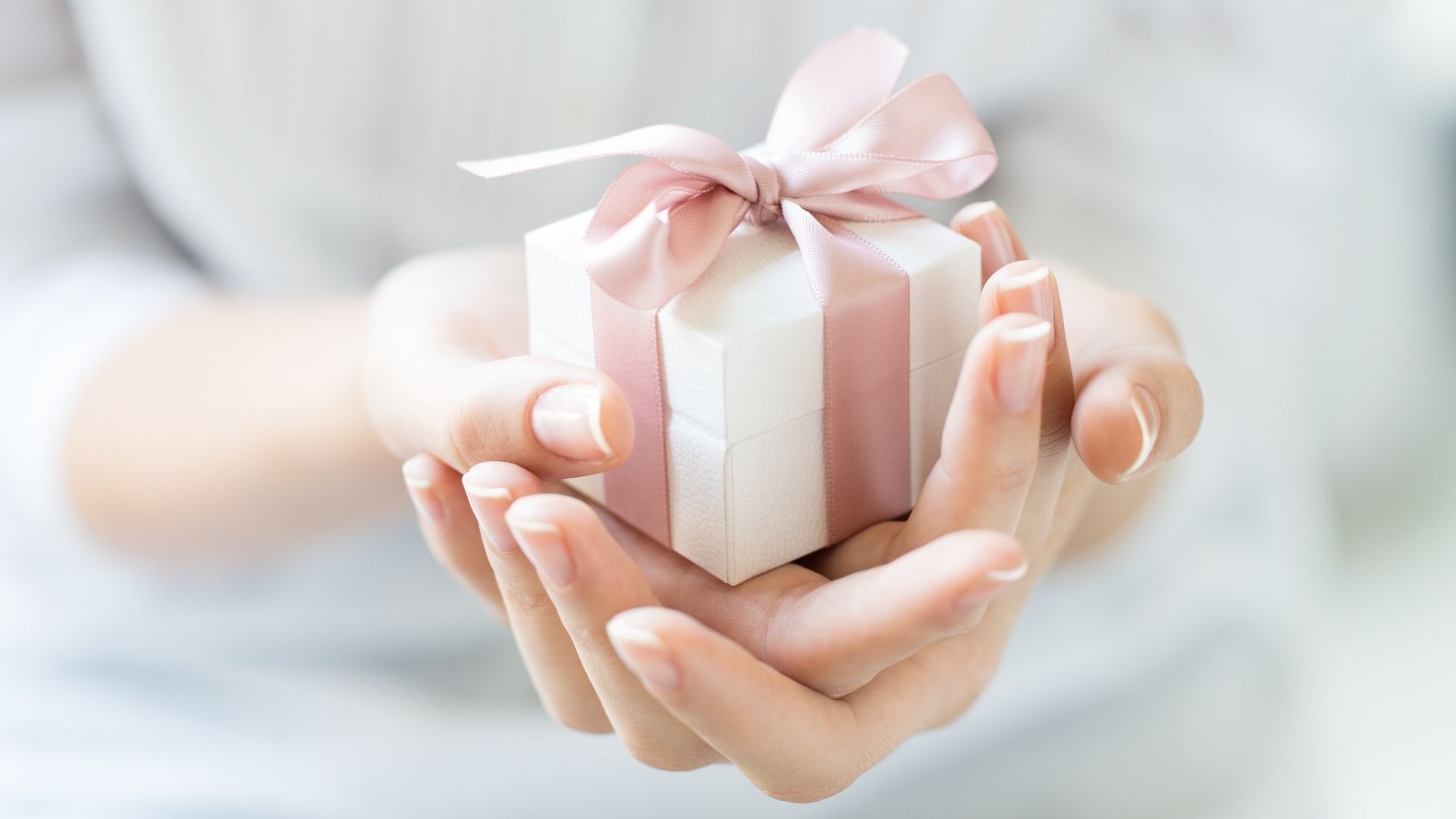 Person holding out small gift