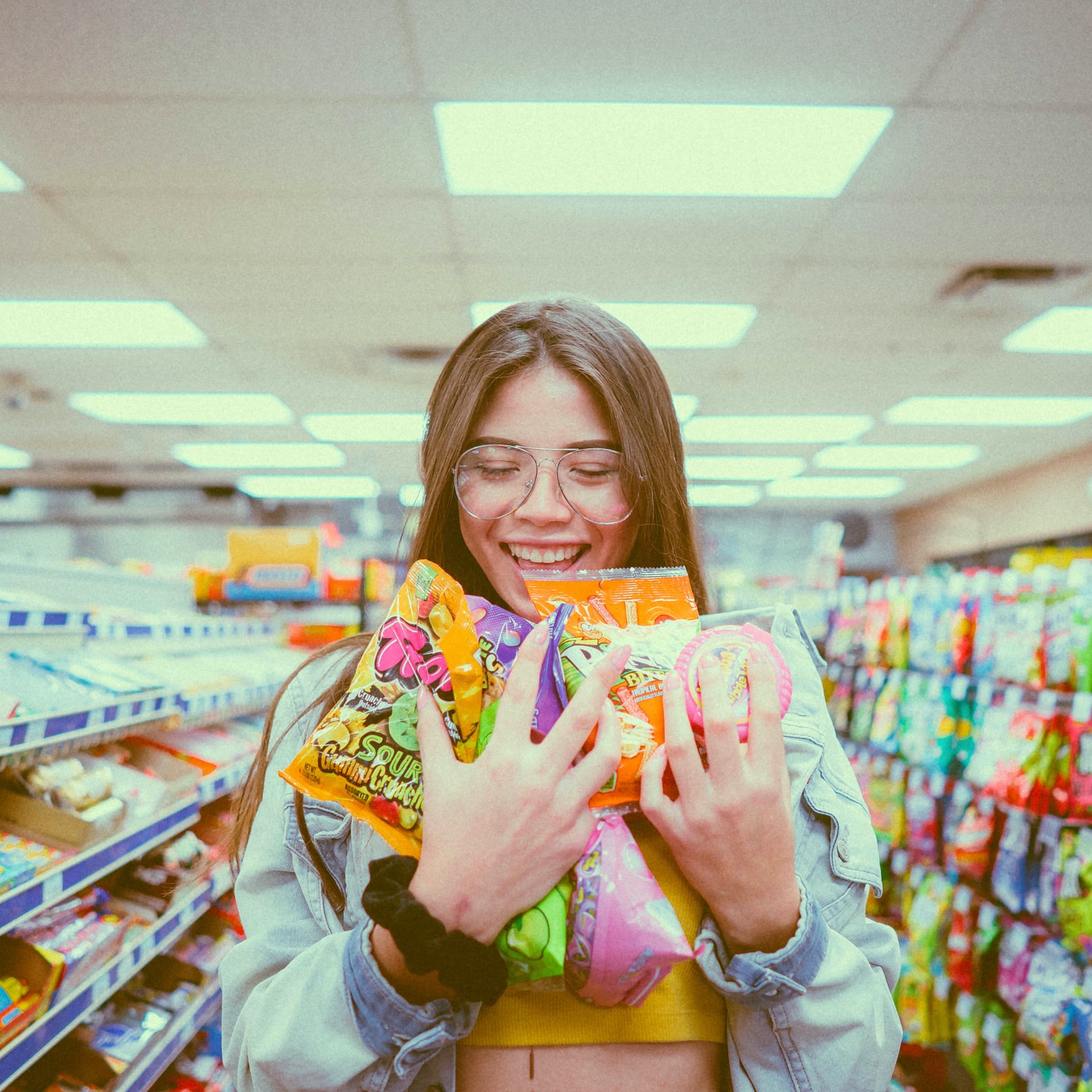Smilling woman holding packs of candy