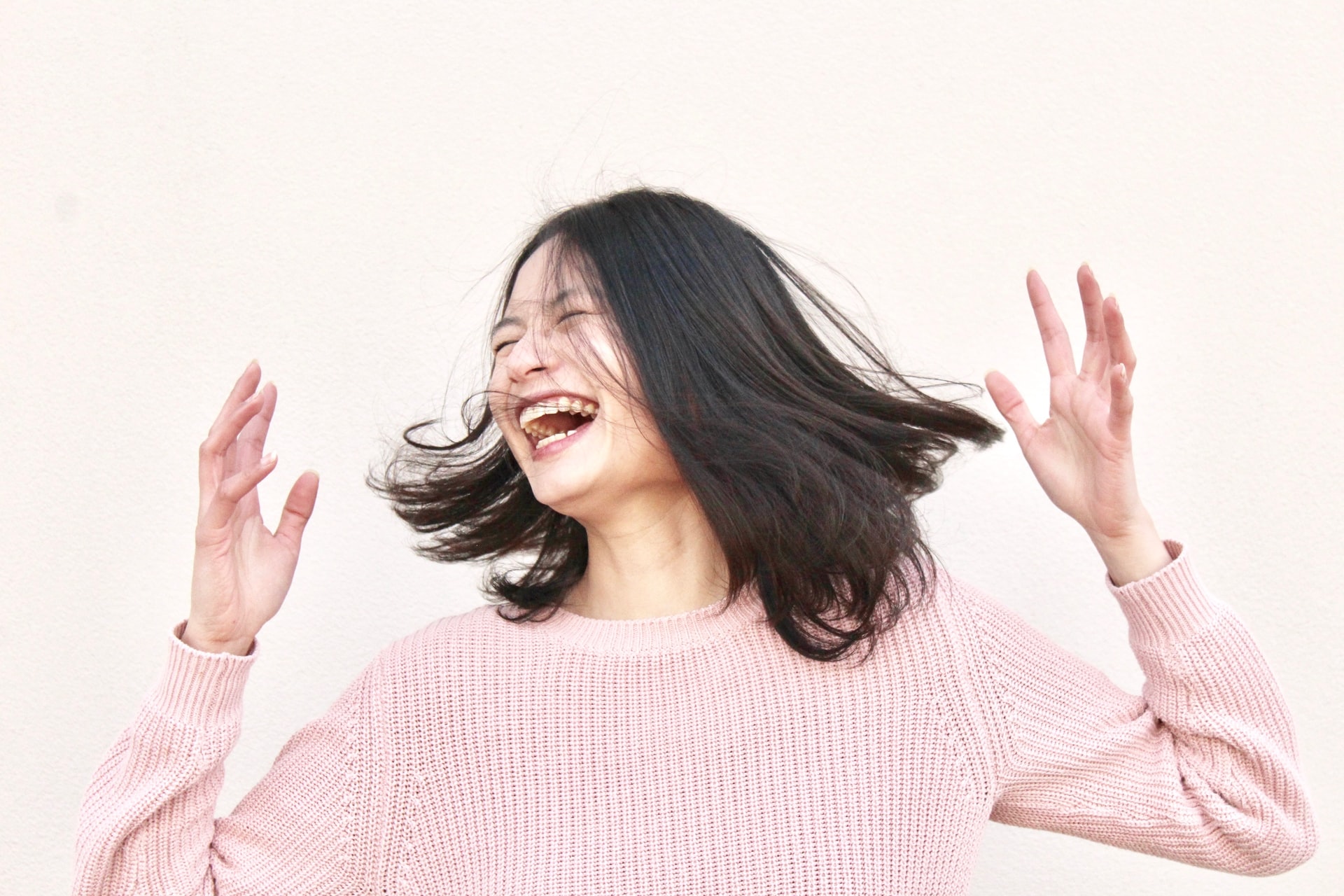 Smilling woman wearing a pink blouse