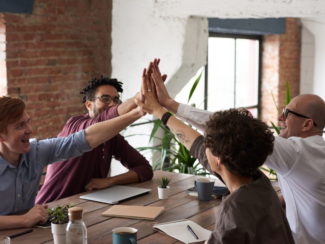 Team members high fiving