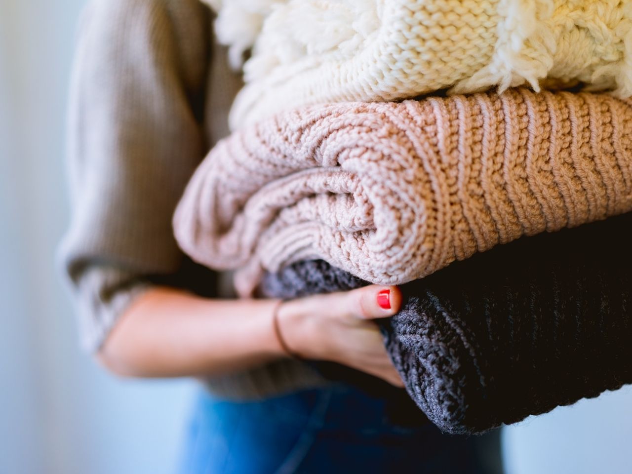 Woman carying colored blankets