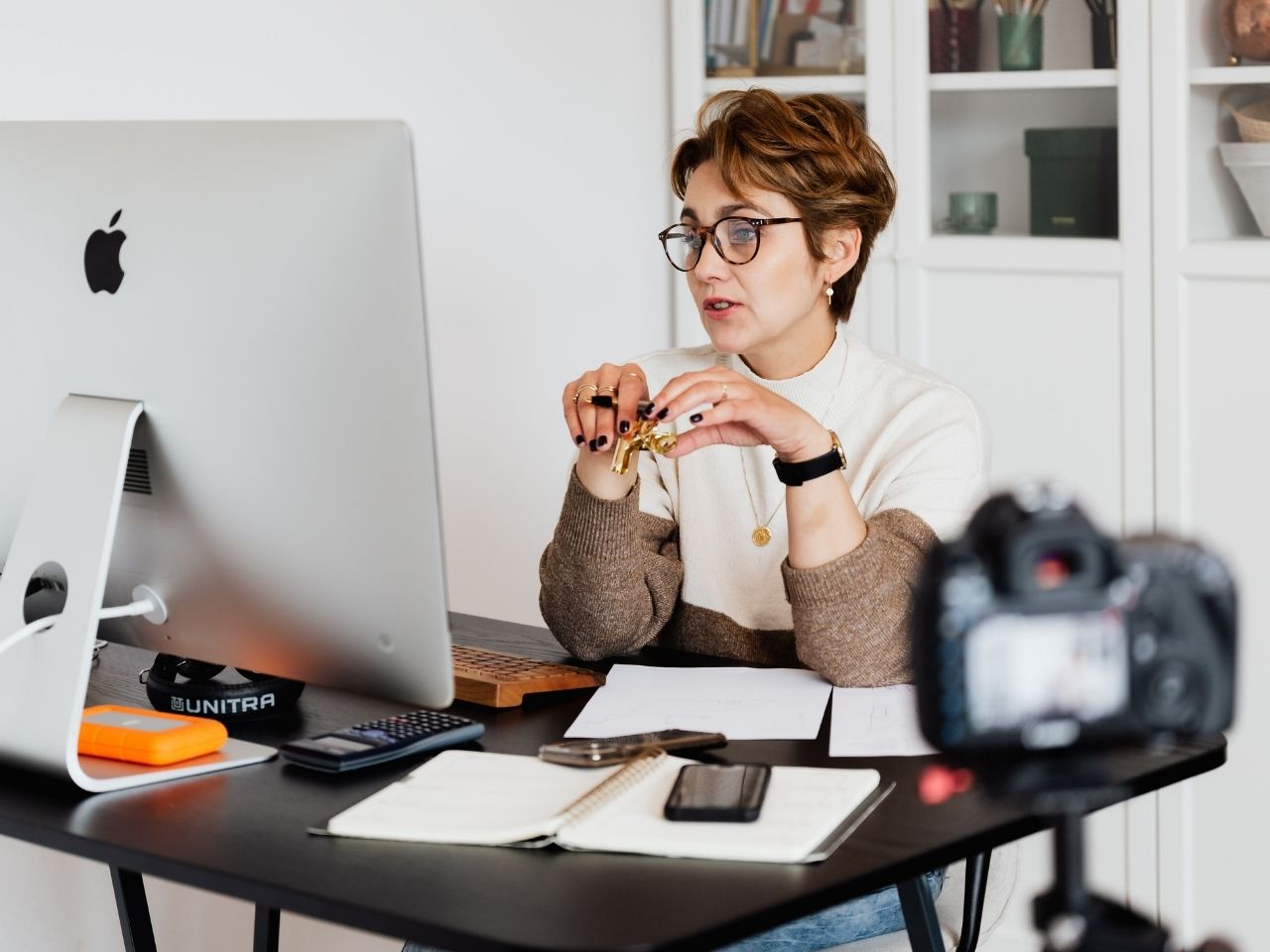 Woman filming herself staying on desk