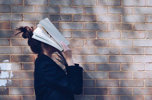 Woman with a book on her face