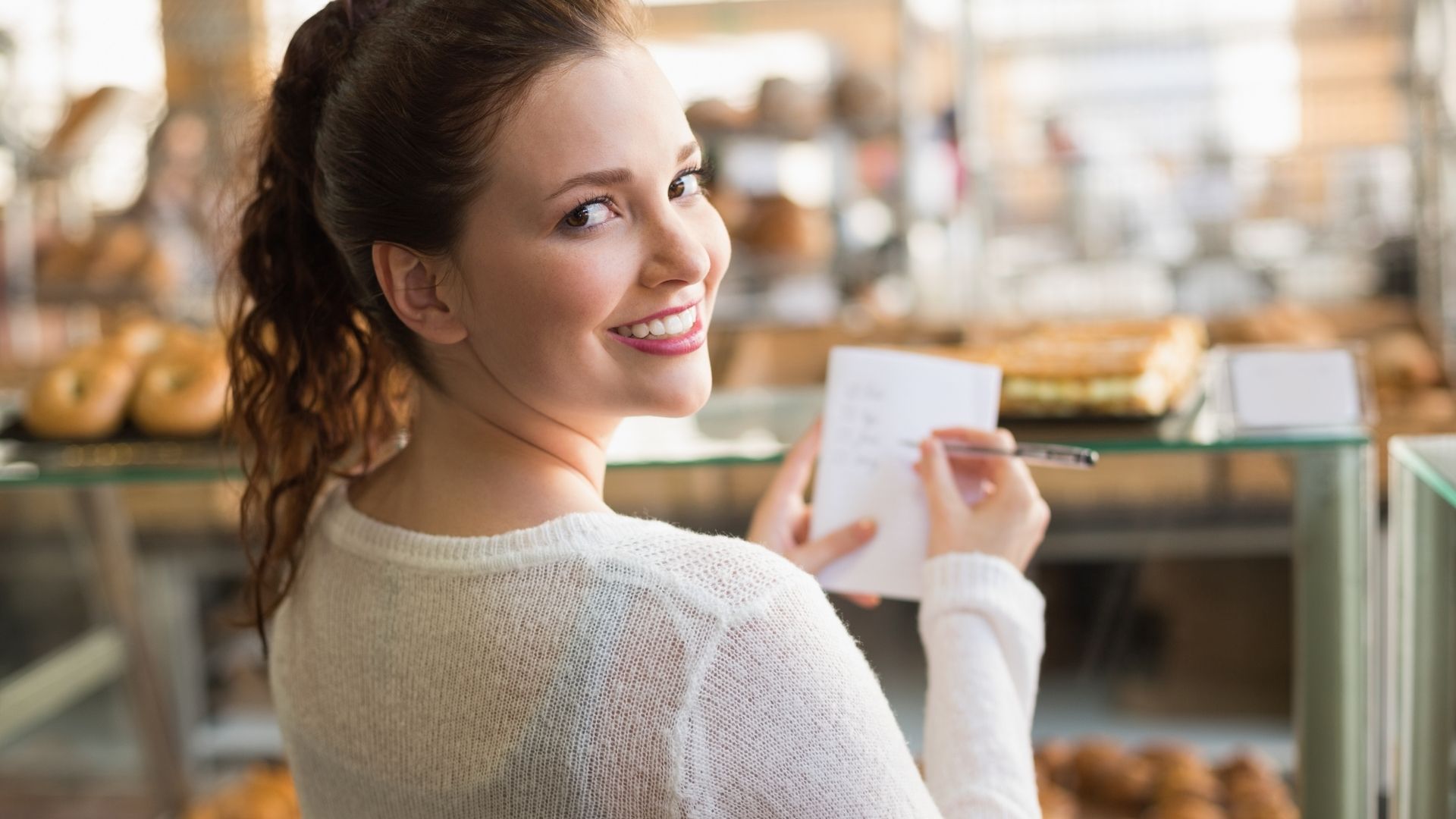 Woman smilling writting a list