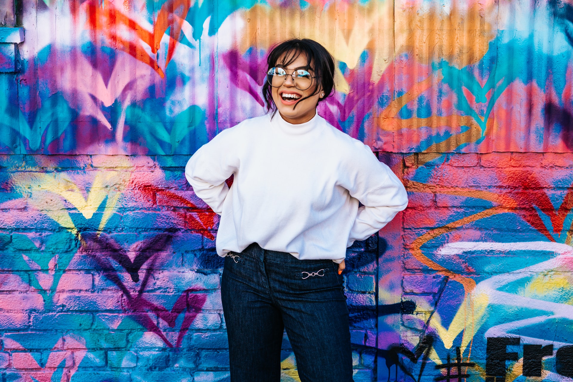 Woman standing in front of colored painted wall