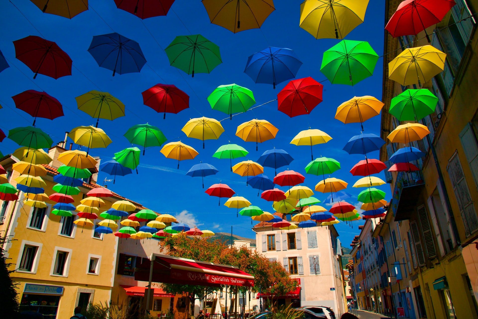 Multi-colored umbrellas in sky