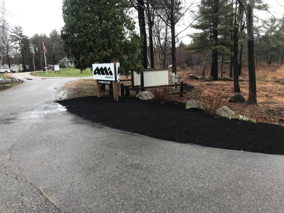 Road sign with bed of bark mulch