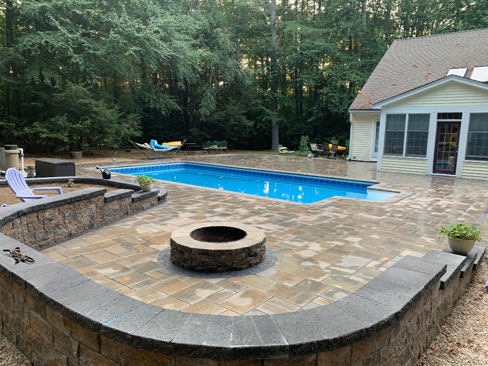 Backyard in ground pool with patio and fire pit