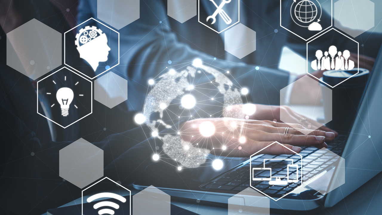 Person at a computer with numerous icons in hexagons around them