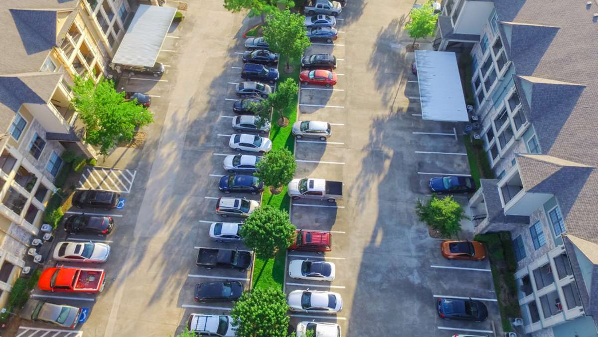 Aerial view of apartment garage with full of covered parking
