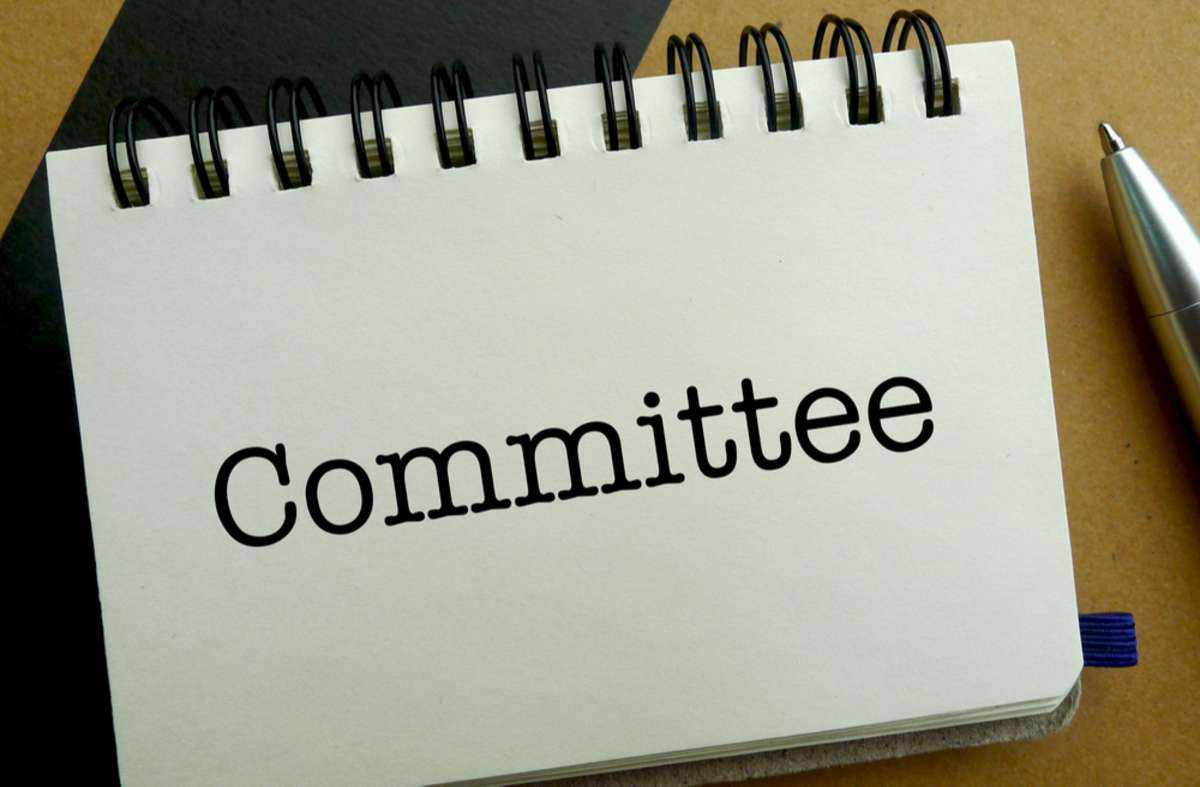 Committee memo written on a notebook with pen