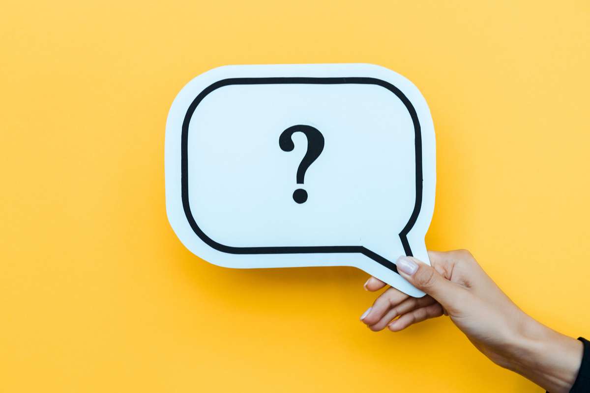 Cropped view of woman holding speech bubble with question mark on orange (R) (S)