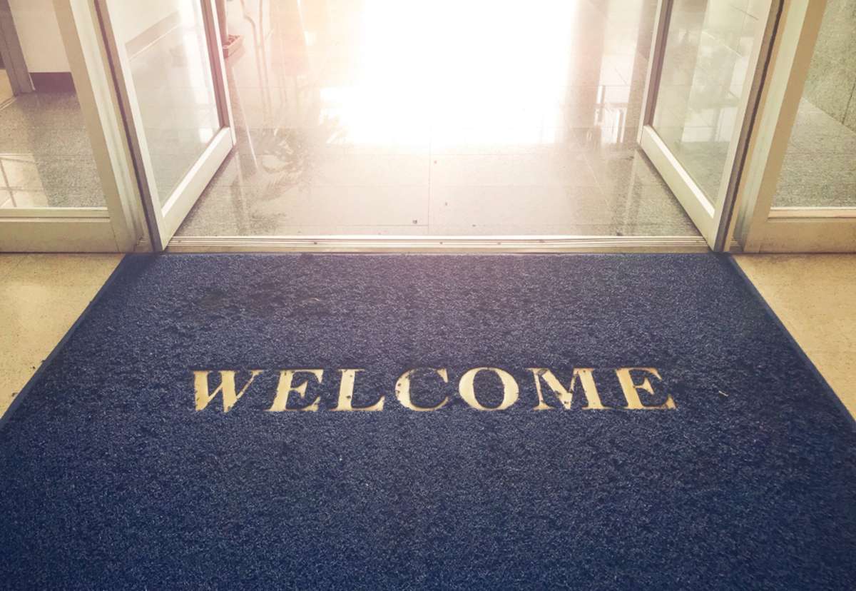 Welcome blue mat in front of door, shop