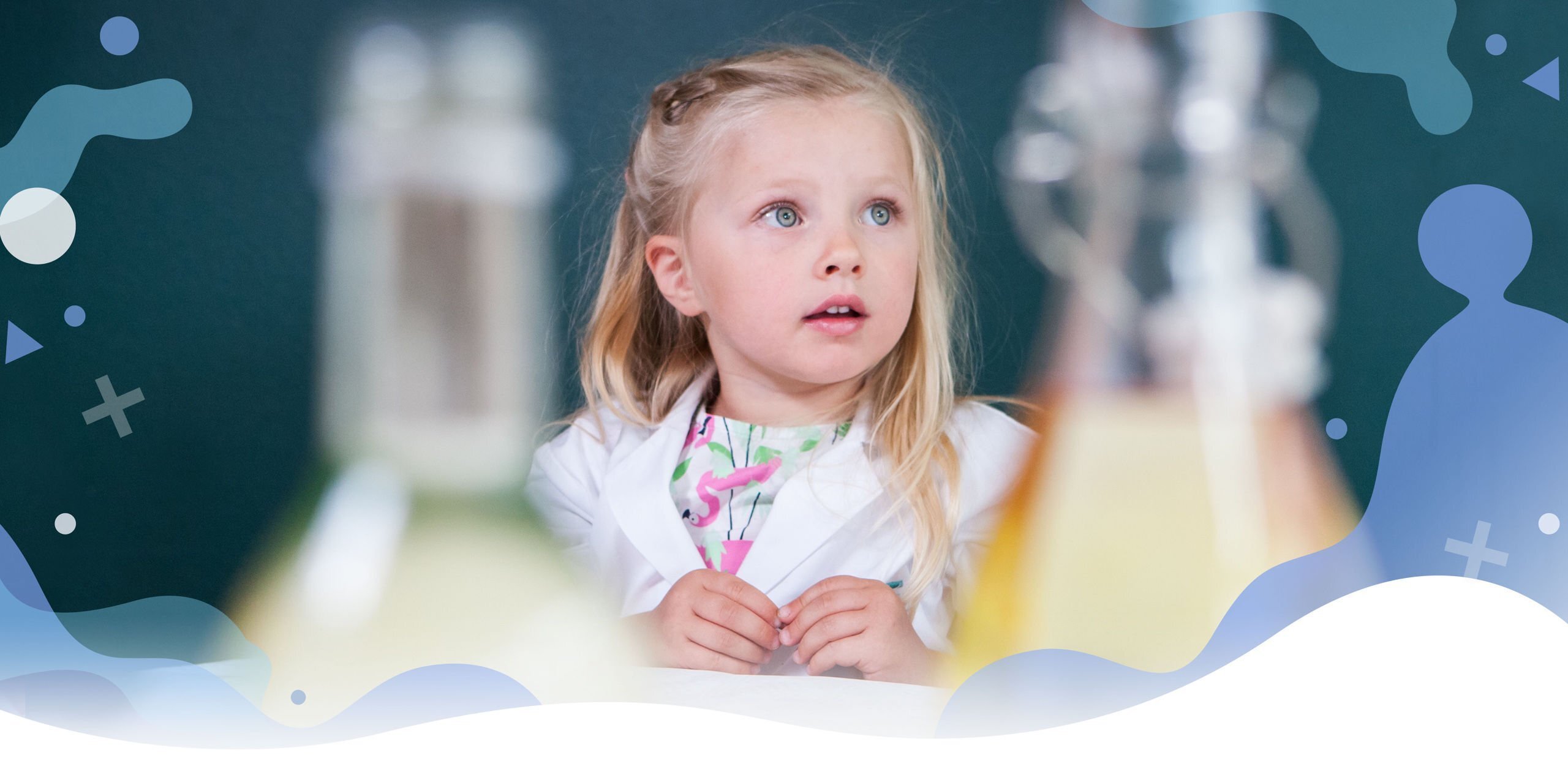 Girl admiring science experiments in a lab coat